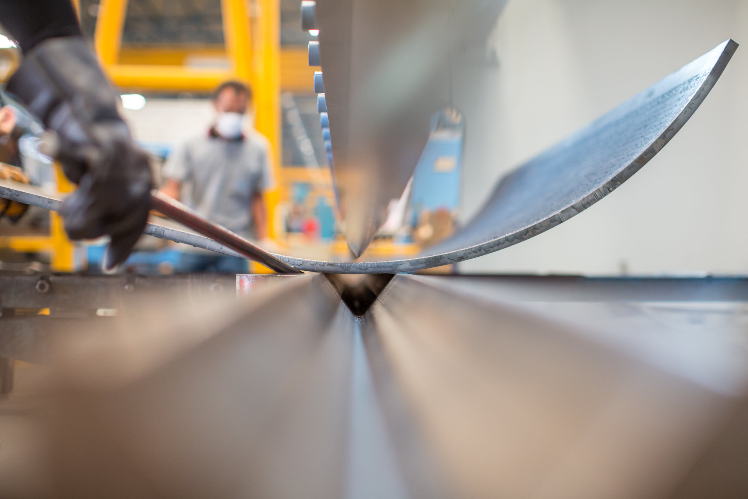 Asian worker in factory at metal workshop – bender